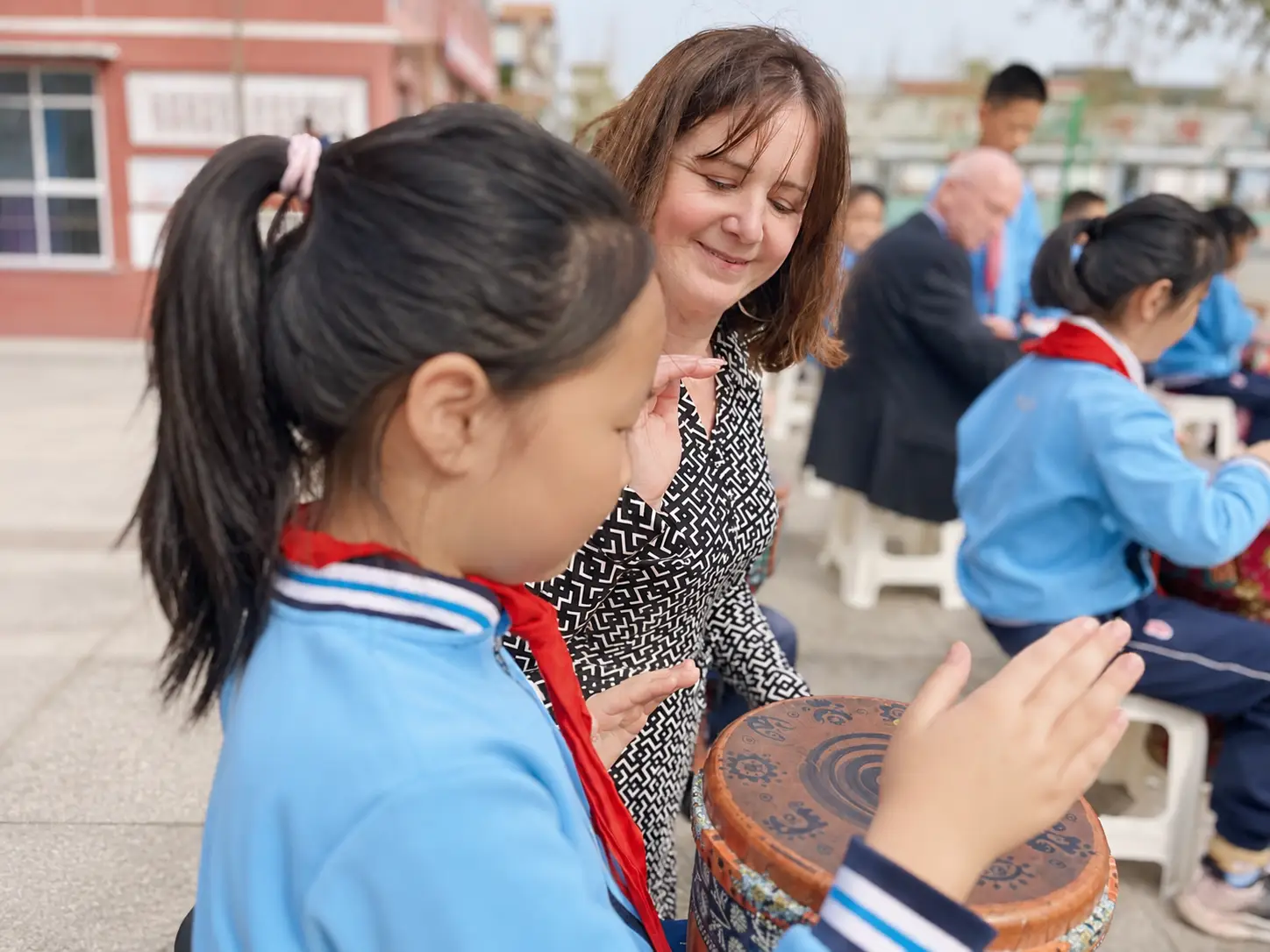 A teacher and pupil interacting during a school learning activity.