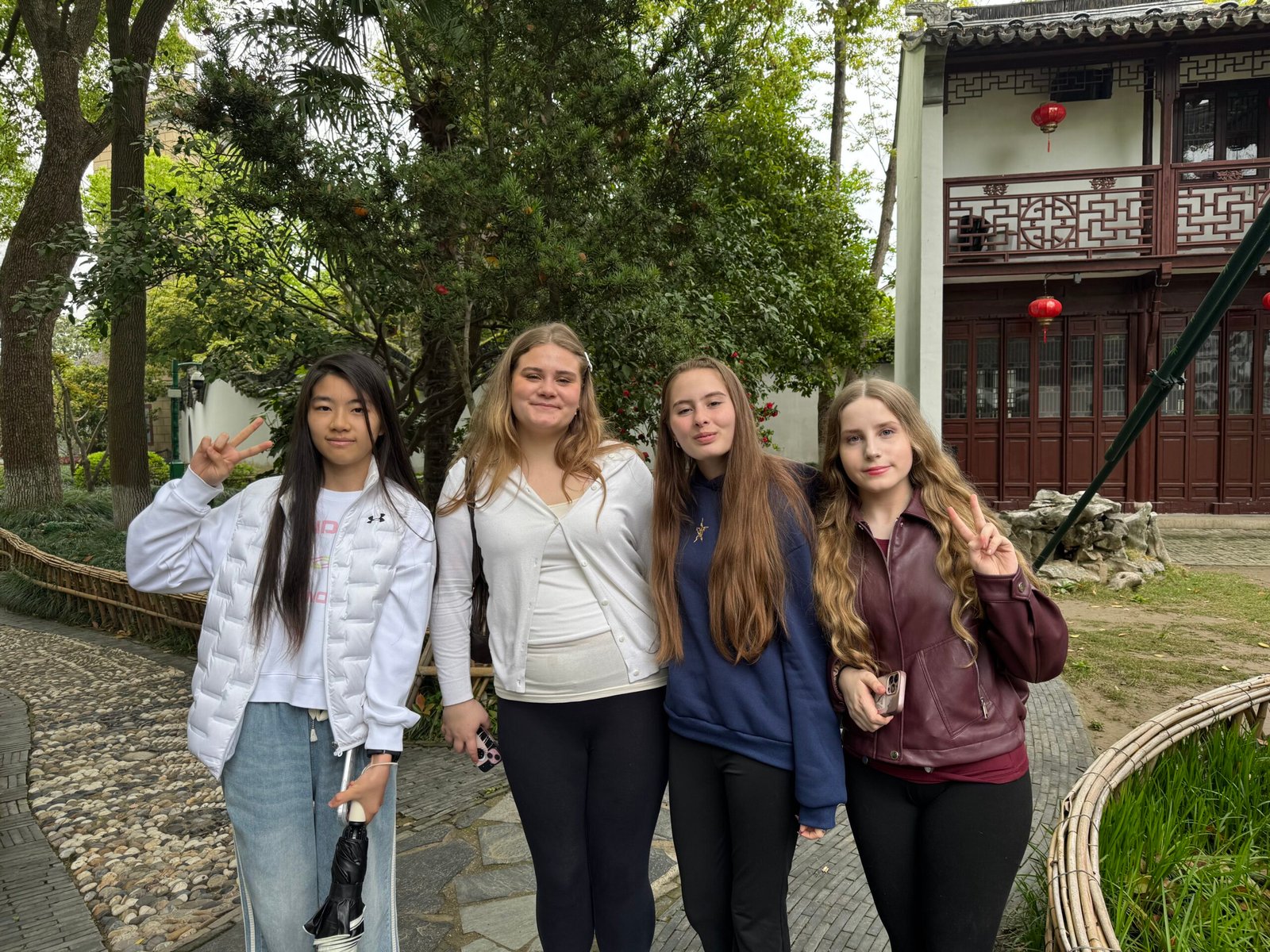Students together in a Chinese garden during their trip